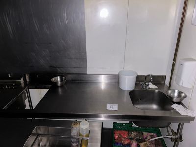 a kitchen with a sink, stove, and a counter top