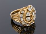 a gold and diamond ring with a knot around the center