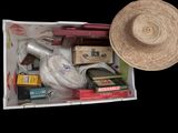 a straw hat sitting on top of a box filled with books