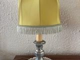 a table with a lamp on it and a doily doily on it