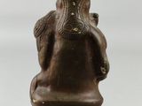 bronze statue of an elephant holding a baby elephant on its back