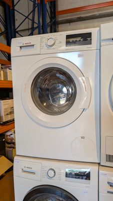 two washers and a dryer stacked on top of each other
