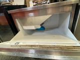 a white refrigerator with a blue handle in a room