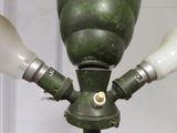 a green lamp that is on top of a metal pole