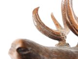 a close up of a statue of a deer with antlers on it ' s head