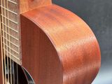 a close up of a guitar on a stand with a black background