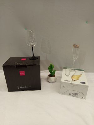 two wine glasses and a box on the bed
