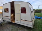 an image of a camper trailer parked in the grass