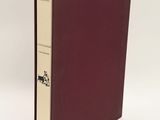 a book with a red cover sitting on top of a white table