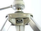 a close up of a tripod with a camera on it