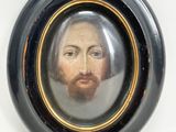 painting of a man with a beard and mustache in a black oval frame
