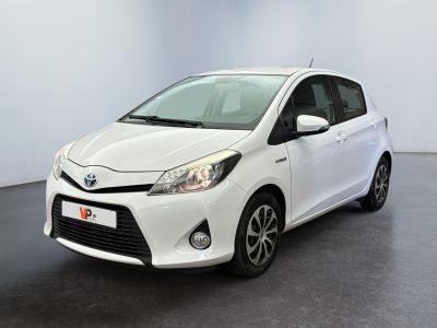 the toyota yaris is parked in a white room with a black floor