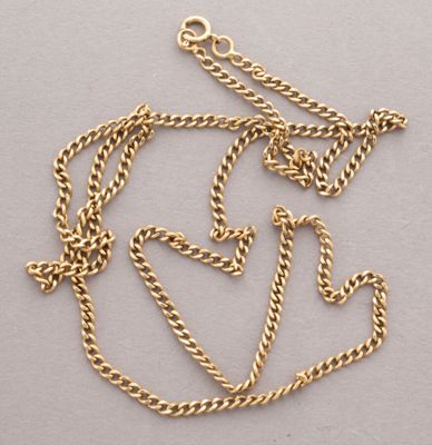 a close up of a gold chain with a heart on it
