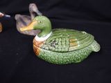 two ducks that are sitting next to each other on a table