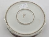 a white bowl with a brown and white design on it