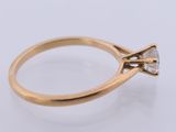 a close up of a gold ring with a diamond on it