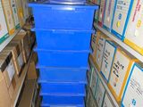 many boxes stacked on top of each other in a room