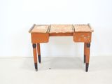 a small wooden desk with two drawers on it