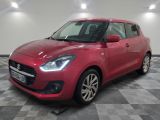 a red suzuki swifty parked in a garage