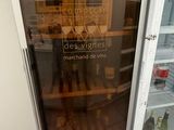 a refrigerator with a glass door that has some food inside of it