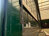 une image représentant un grand bâtiment vert doté de nombreuses fenêtres