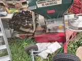 a green machine that is sitting in the grass