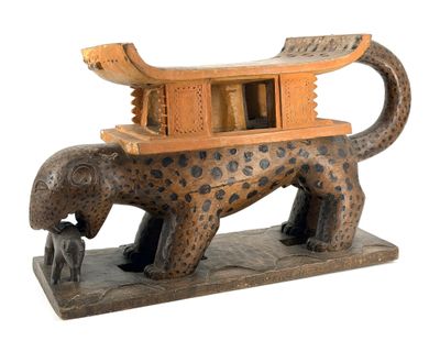 statue of a leopard with a house on its back