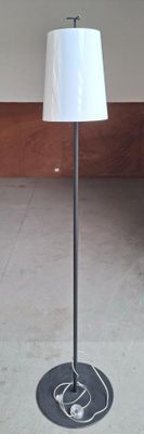 a lamp that is sitting on a stand in a room