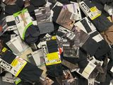 many pairs of black and white socks on a pile