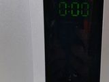 a digital clock on the side of a microwave
