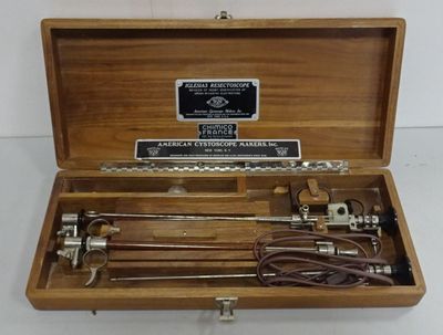 a wooden box with tools in it on a white surface