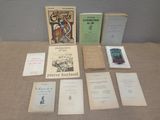 several books are sitting on a table next to each other