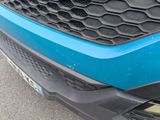 a close up of the front bumper of a blue car