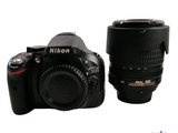 a black camera and a black lens sitting next to each other