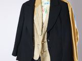 a suit and vest hanging on a hanger