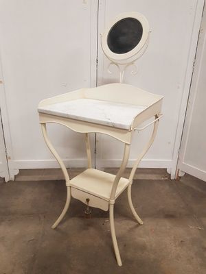 une petite table blanche sur laquelle est posé un miroir