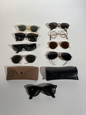 several pairs of sunglasses are displayed on a white surface