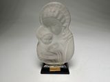 a white marble statue of a woman holding a child