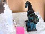a statue of a horse and a fire hydrant on a table