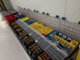 many bins of assorted legos on a conveyor belt