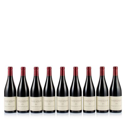 six bottles of red wine lined up in a row