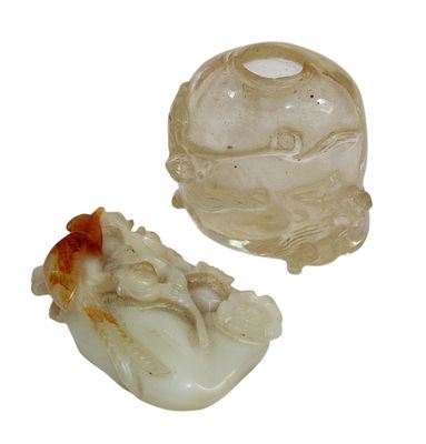 two pieces of carved glass on a white surface