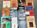 several books are stacked on top of each other on the ground
