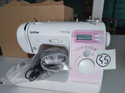 a pink sewing machine sitting on a white table