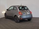 the small car is parked in the large room on the tile floor