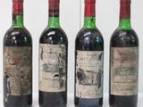 three bottles of red wine are lined up on a table
