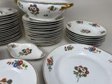 a lot of plates and bowls that are sitting on a table