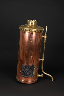 an antique copper and brass coffee pot with a brass handle
