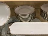 many plates and bowls stacked on a shelf in a cabinet