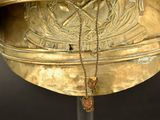 a large brass bell with a chain hanging from it